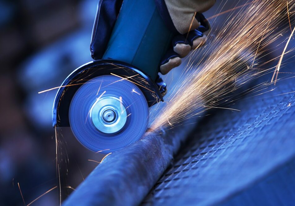 Construction worker using an angle grinder